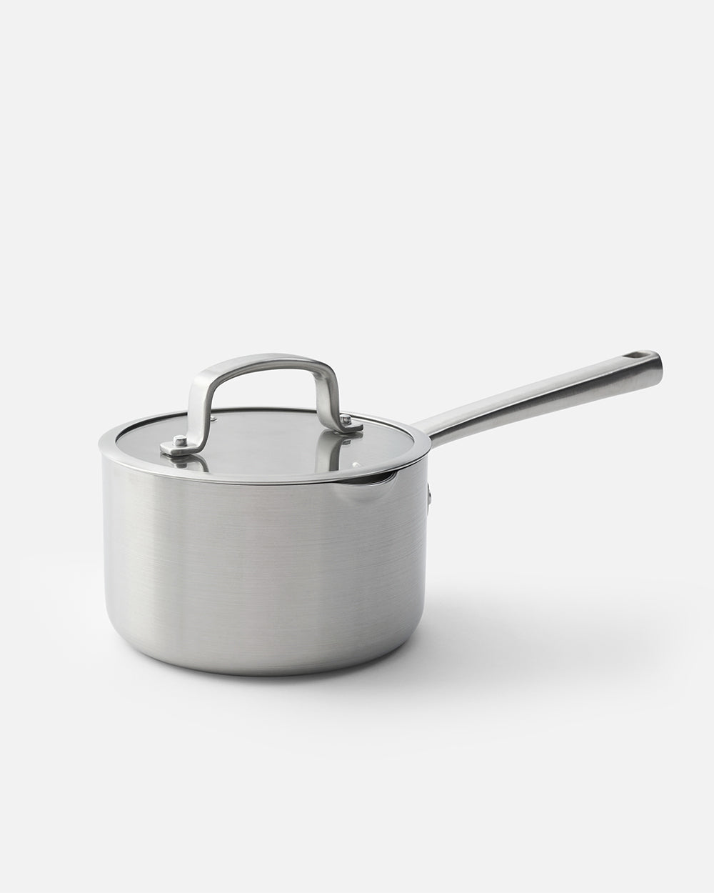 Stainless steel saucepan with lid and long handle on white background