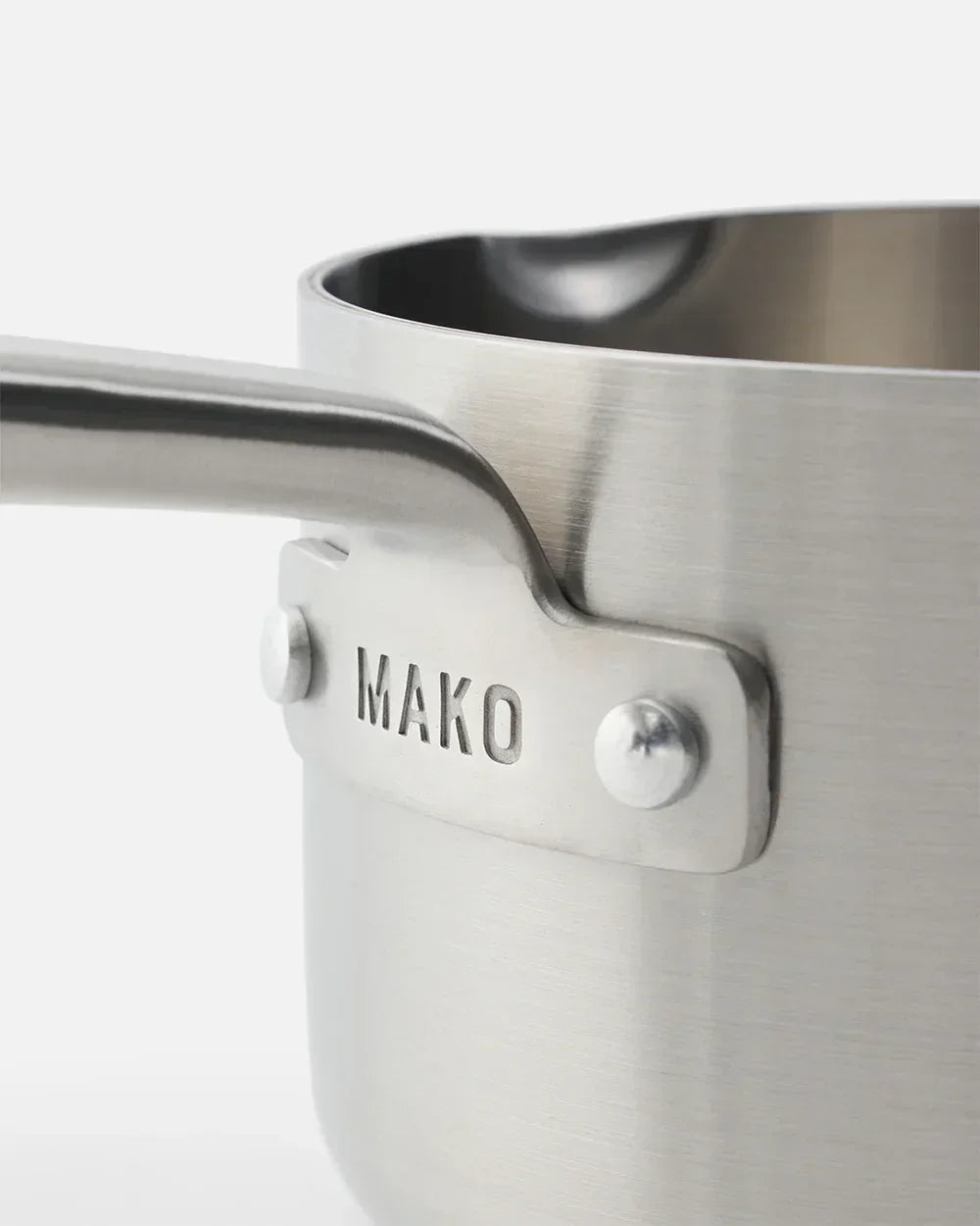 Close-up of stainless steel saucepan handle with MAKO brand name embossed