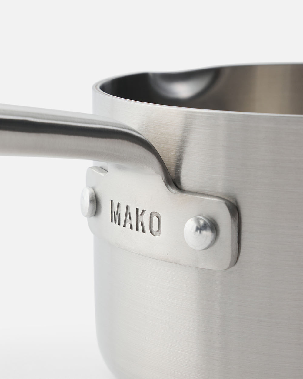 Close-up of stainless steel MAKO saucepan with riveted handle and pouring spout