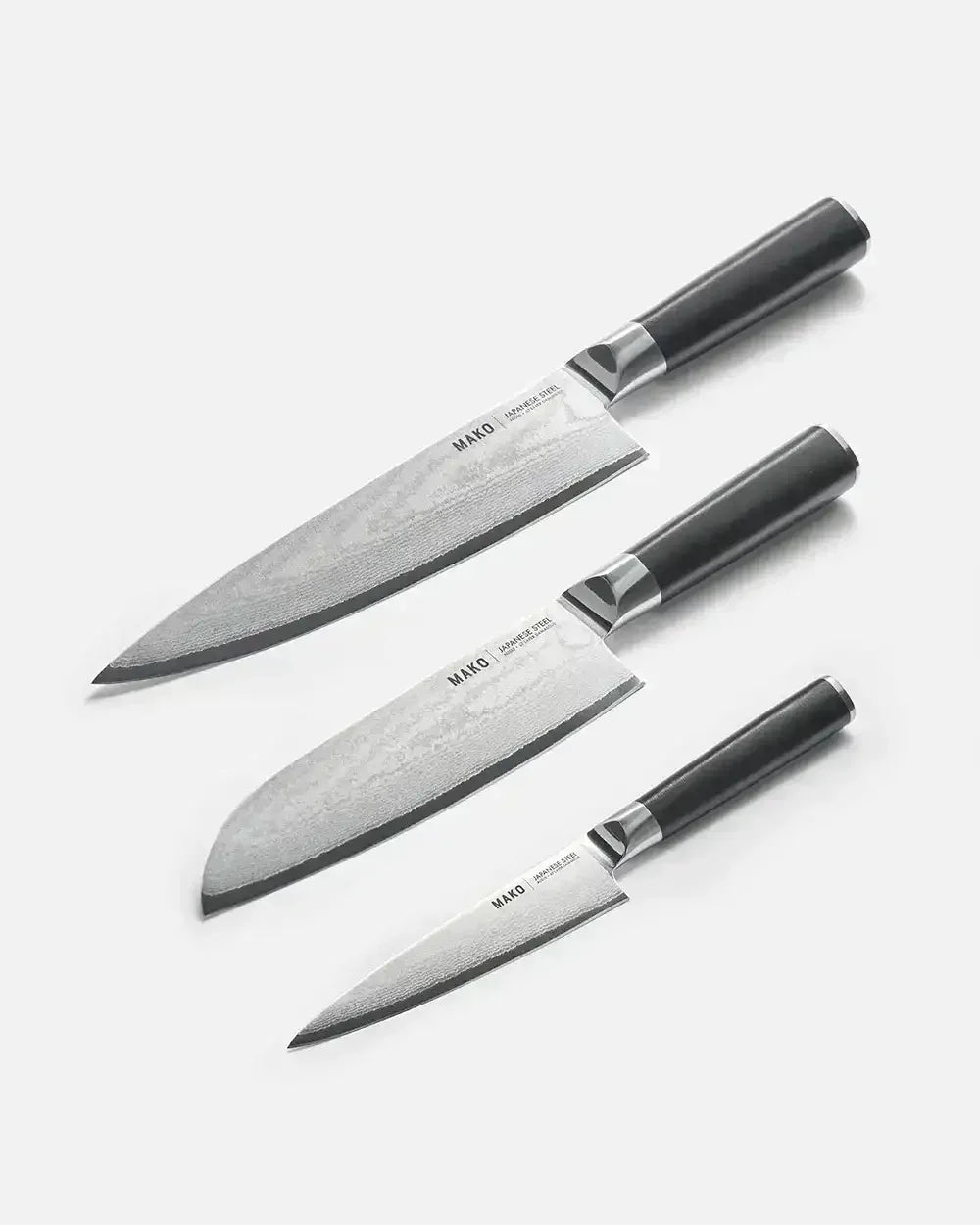 Set of three MAKO Japanese steel kitchen knives with black handles on white background
