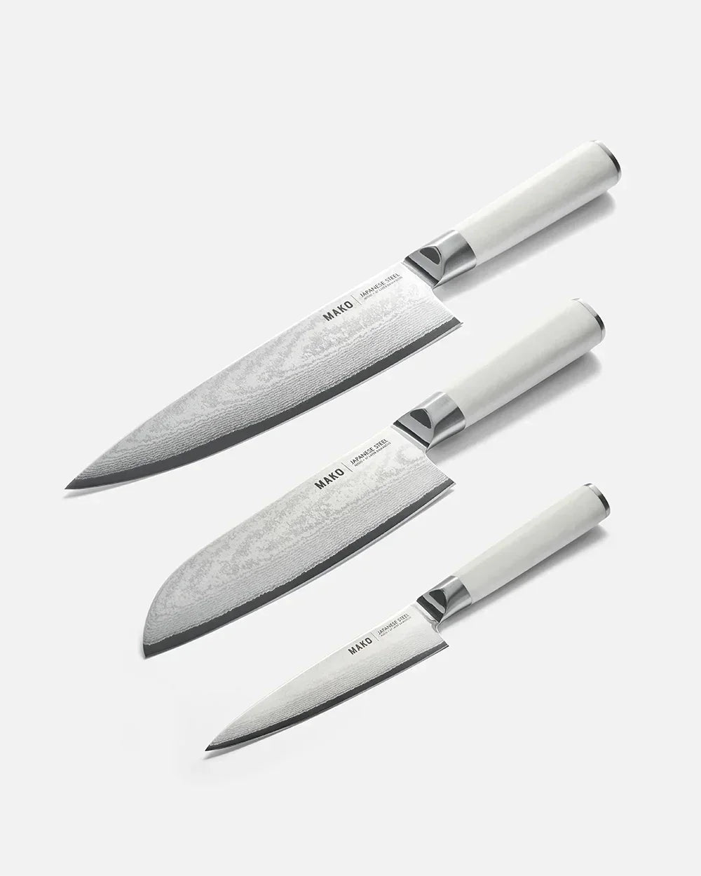 Set of three Mako Japanese steel kitchen knives with white handles by Marion Grasby
