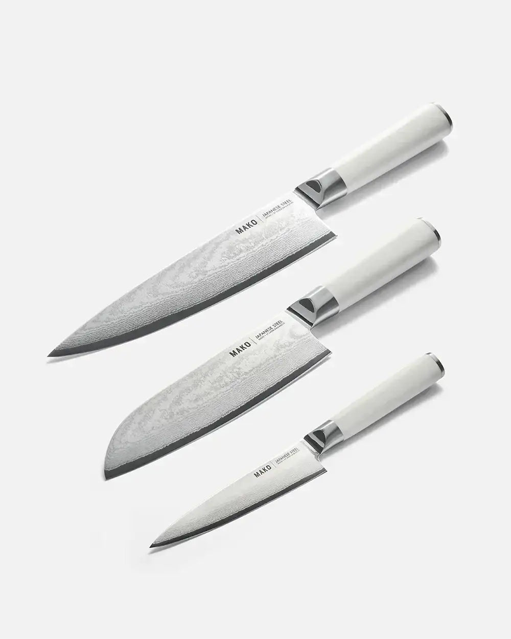 Set of three Mako Japanese steel kitchen knives with white handles by Marion Grasby