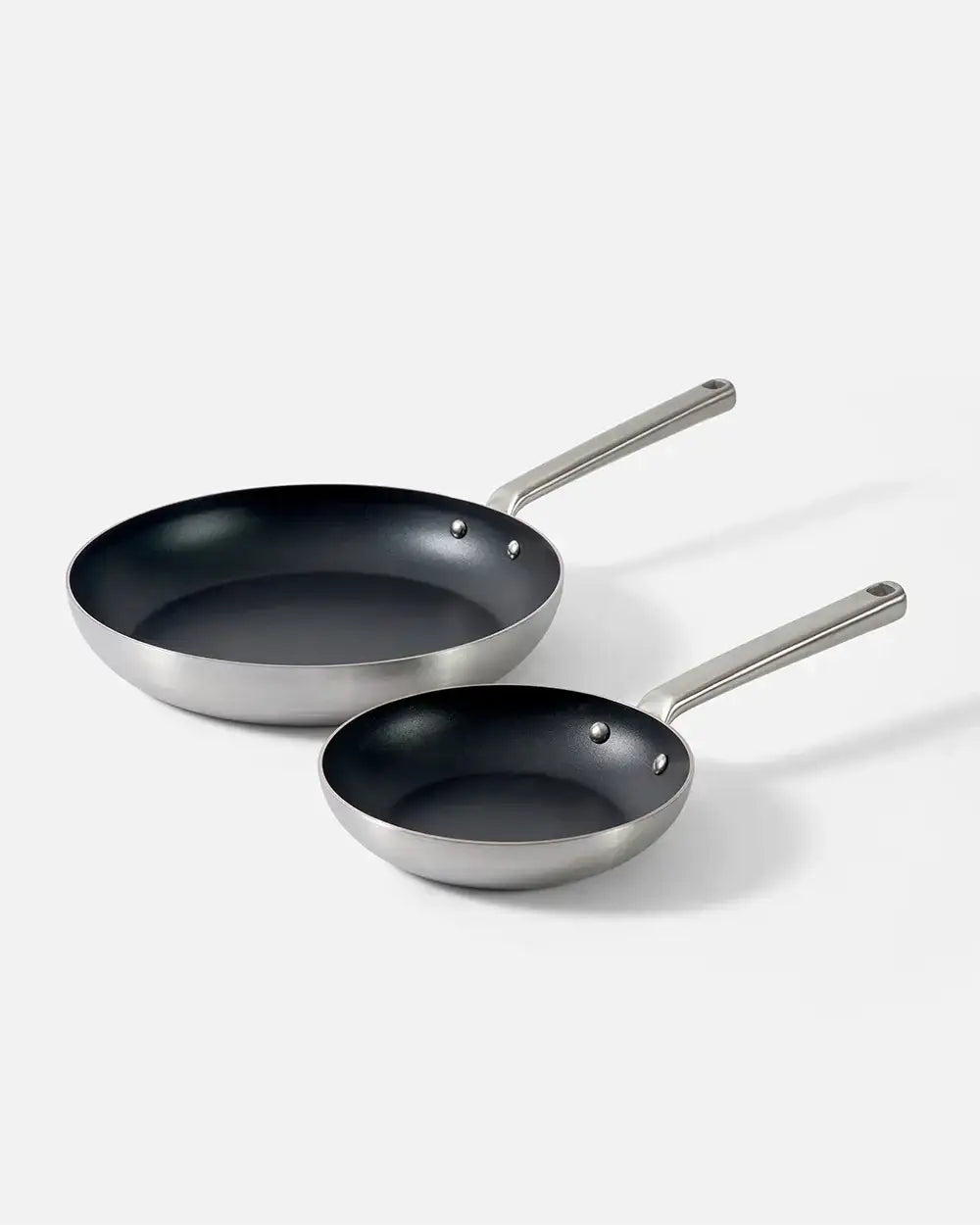 Two Mako non-stick frying pans with stainless steel handles on white background by chef Marion Grasby
