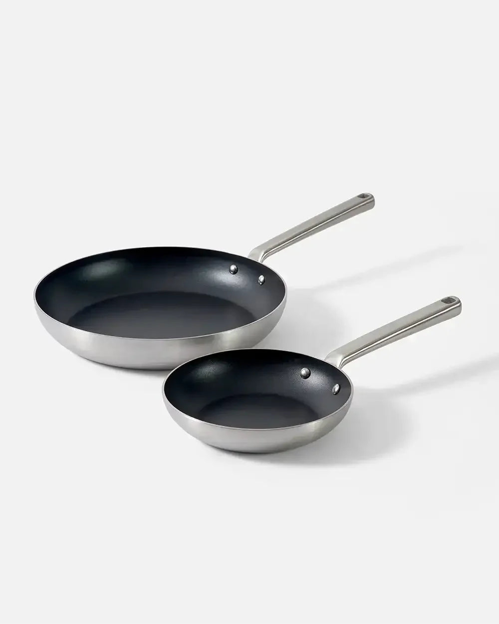 Two non-stick frying pans with stainless steel handles on a white background
