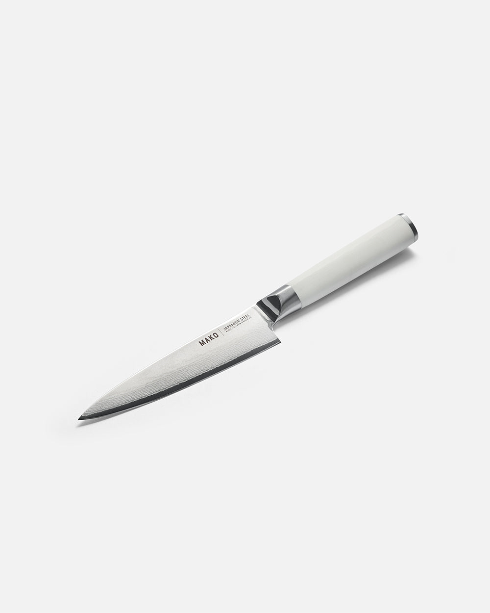 Japanese steel utility knife with white handle on plain background
