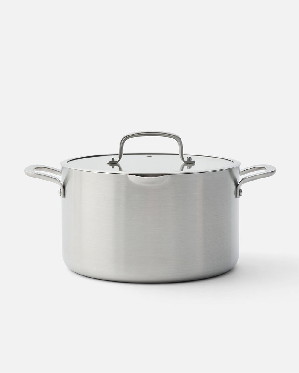 Stainless steel stockpot with lid and side handles on white background
