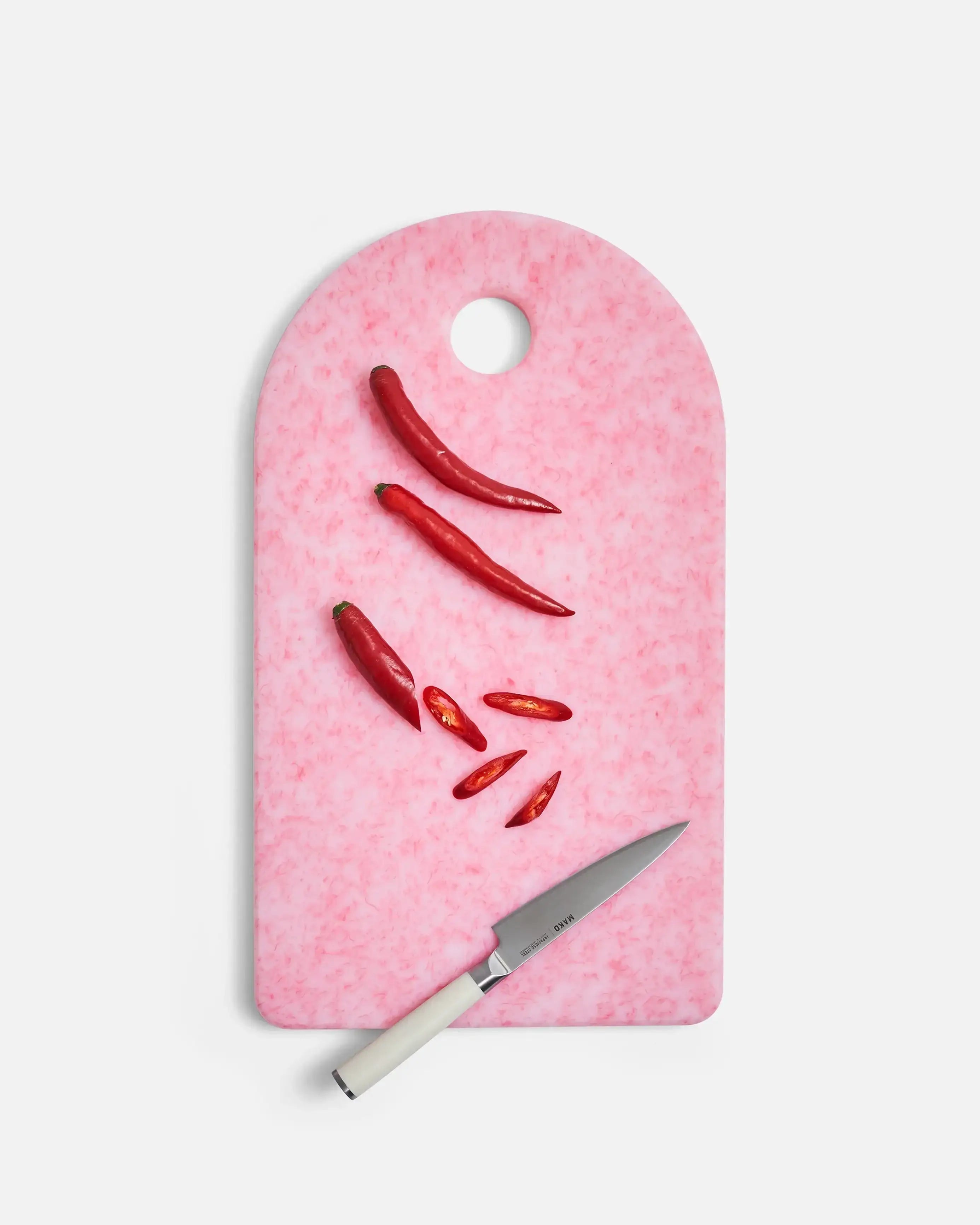 Mako chef knife and sliced red chilies on pink cutting board from CookDineHost