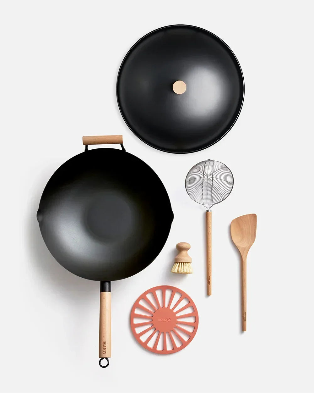 Black Mako wok with lid, wooden handle spatula, skimmer, brush, and silicone trivet by Marion Grasby