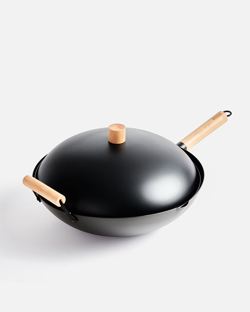 Black carbon steel wok with wooden handles and lid on white background