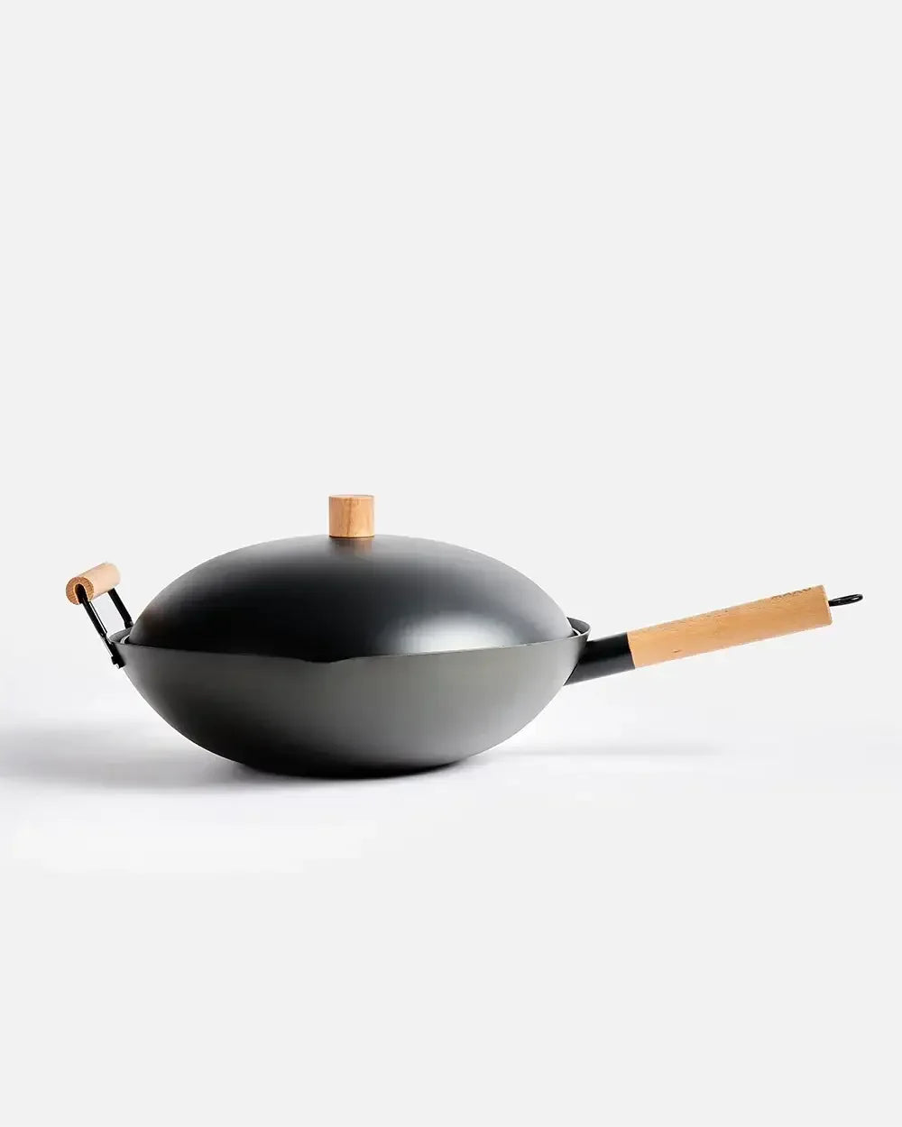 Black wok with lid and wooden handles on a white background, modern cookware utensil