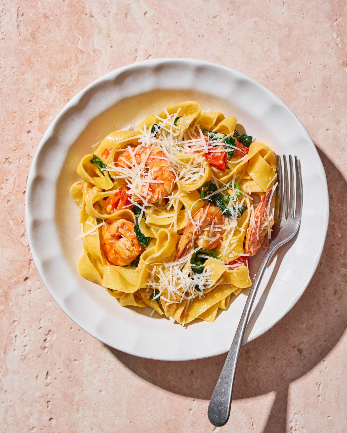 Creamy Garlic Prawn Pappardelle CookDineHost Recipe completed dish in Calida Pasta bowl on marble benchtop with fork