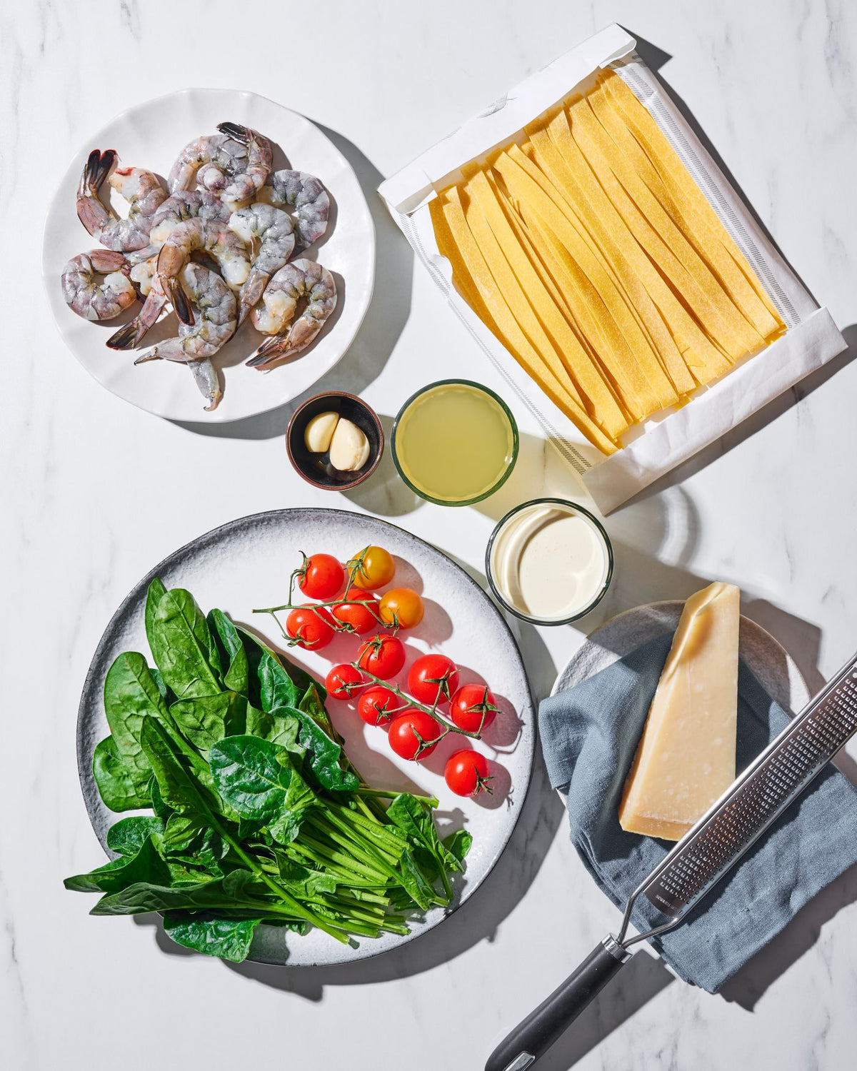 Creamy Garlic Prawn Pappardelle CookDineHost Recipe Ingredients laid flat on marble bench