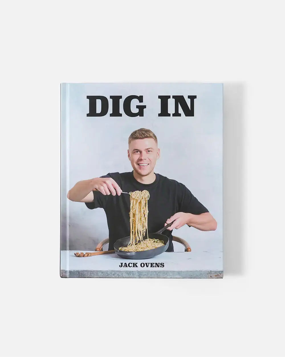 Cookbook "Dig In" by Jack Ovens featuring him holding spaghetti from a pan on cover