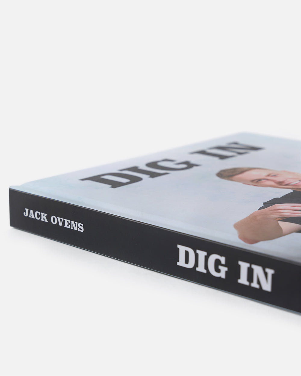 Close-up of 'DIG IN' cookbook by Jack Ovens with partial portrait on the cover