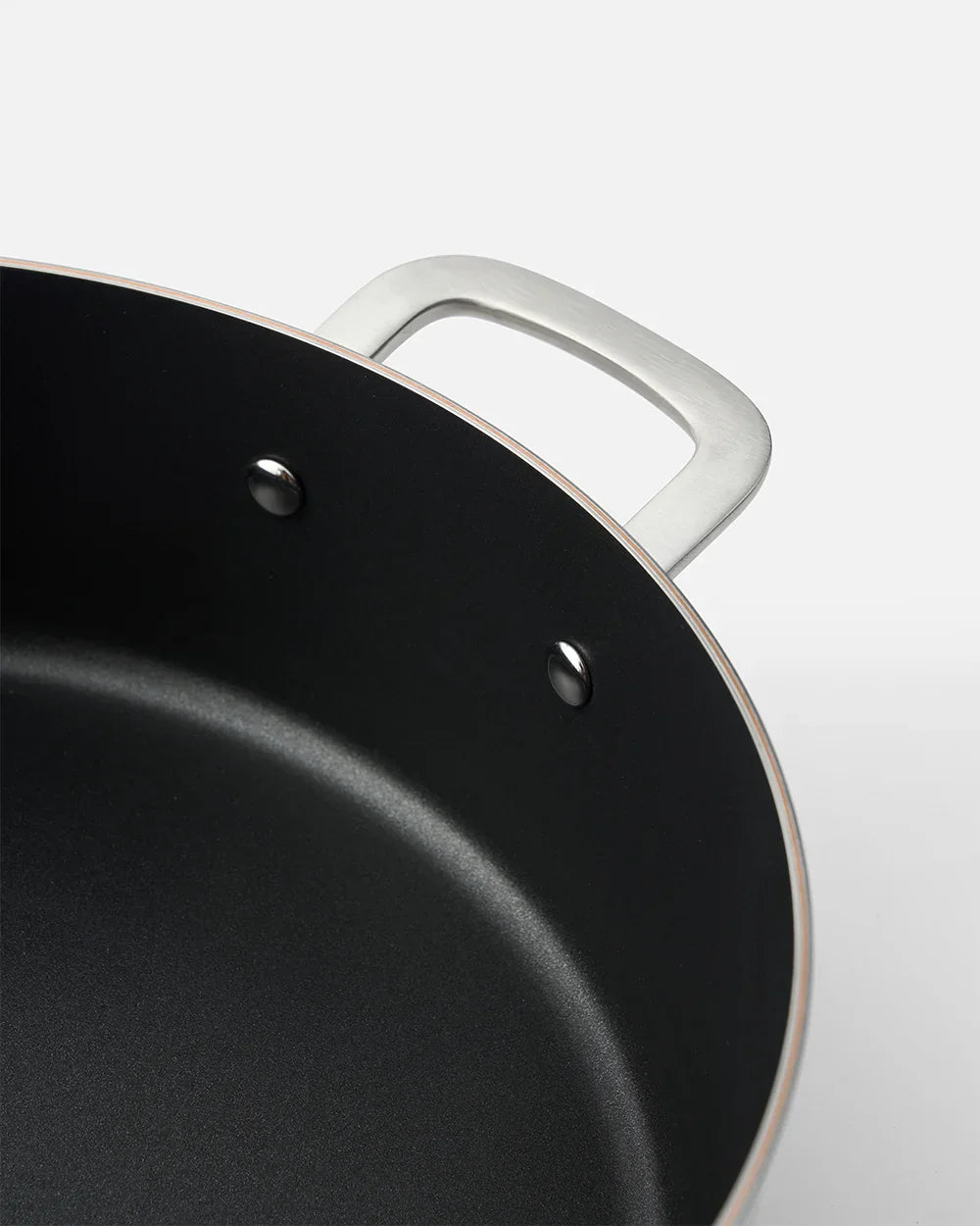 Close-up of black nonstick pan with silver handle, Marion Grasby Mako cookware