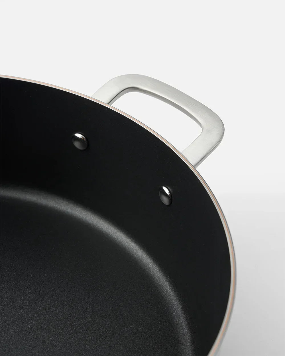 Close-up of black nonstick pan with silver handle, Marion Grasby Mako cookware