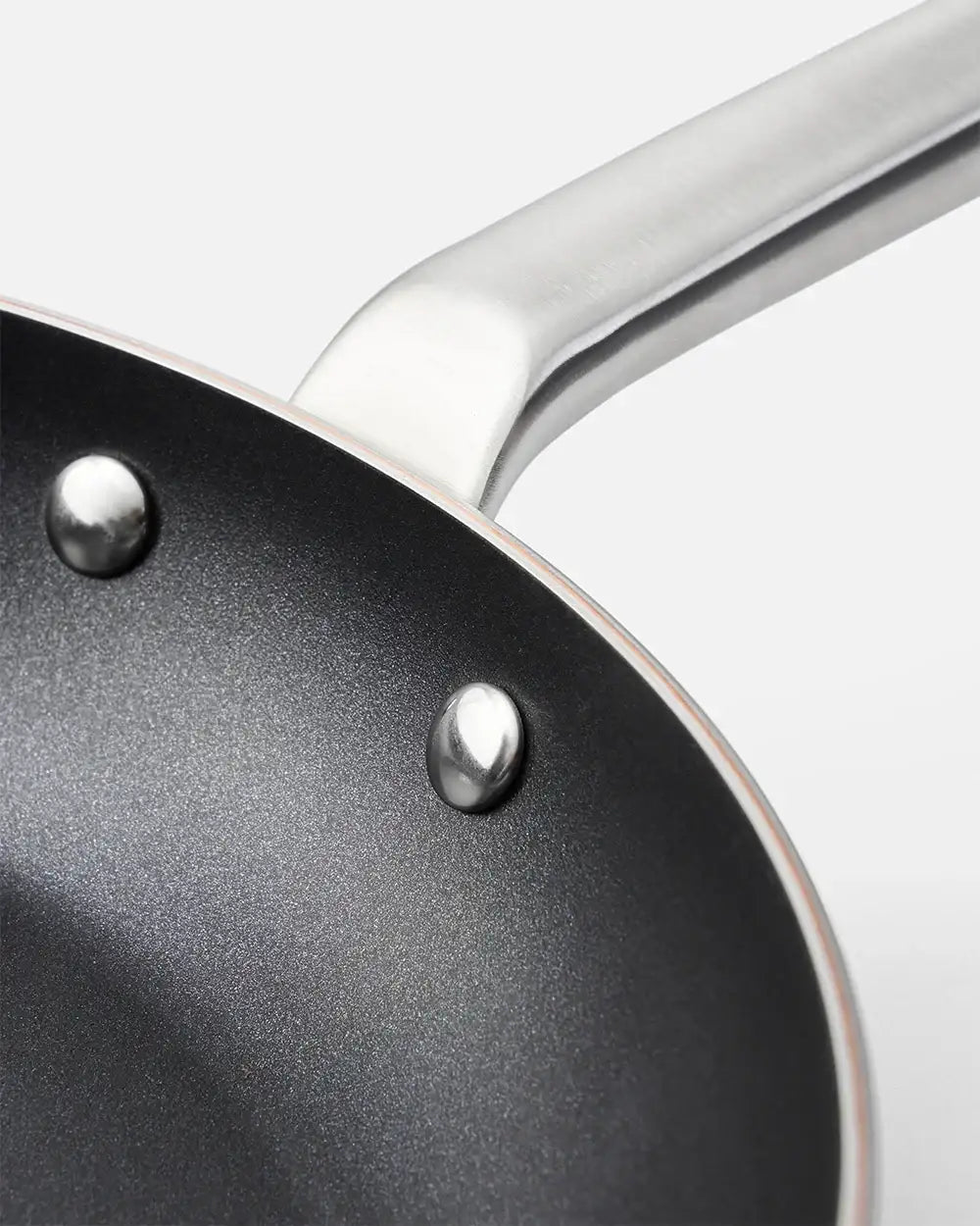 Close-up of Marion Grasby Mako non-stick frying pan with riveted steel handle