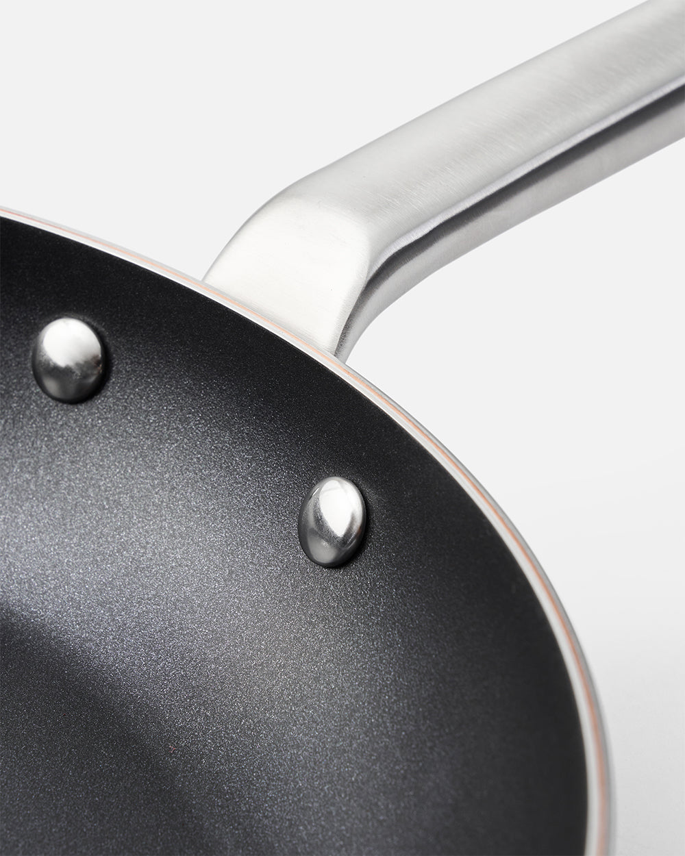 Close-up of nonstick frying pan interior with stainless steel handle