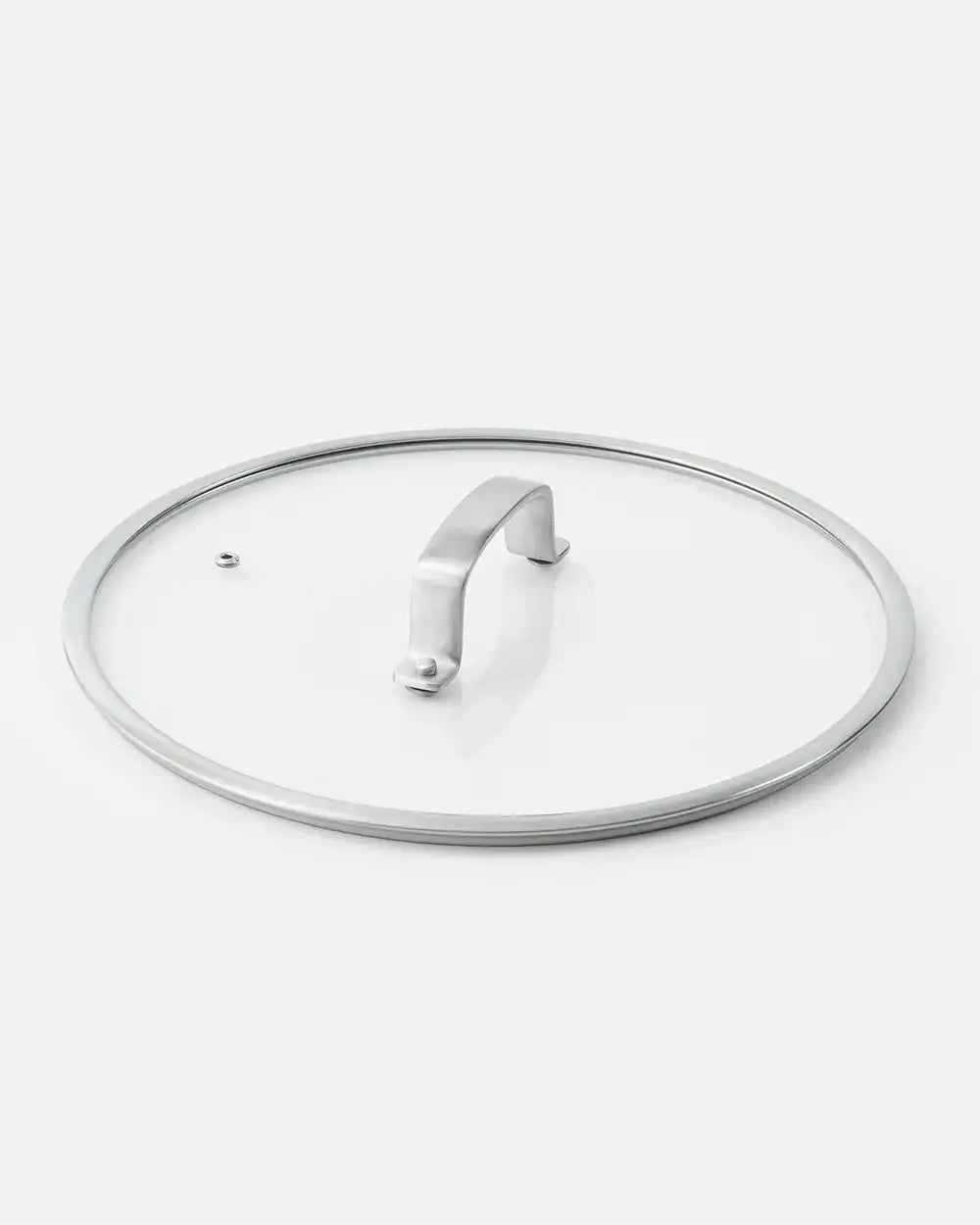 Stainless steel cooking lid with handle and vent hole on white background by Marion Grasby
