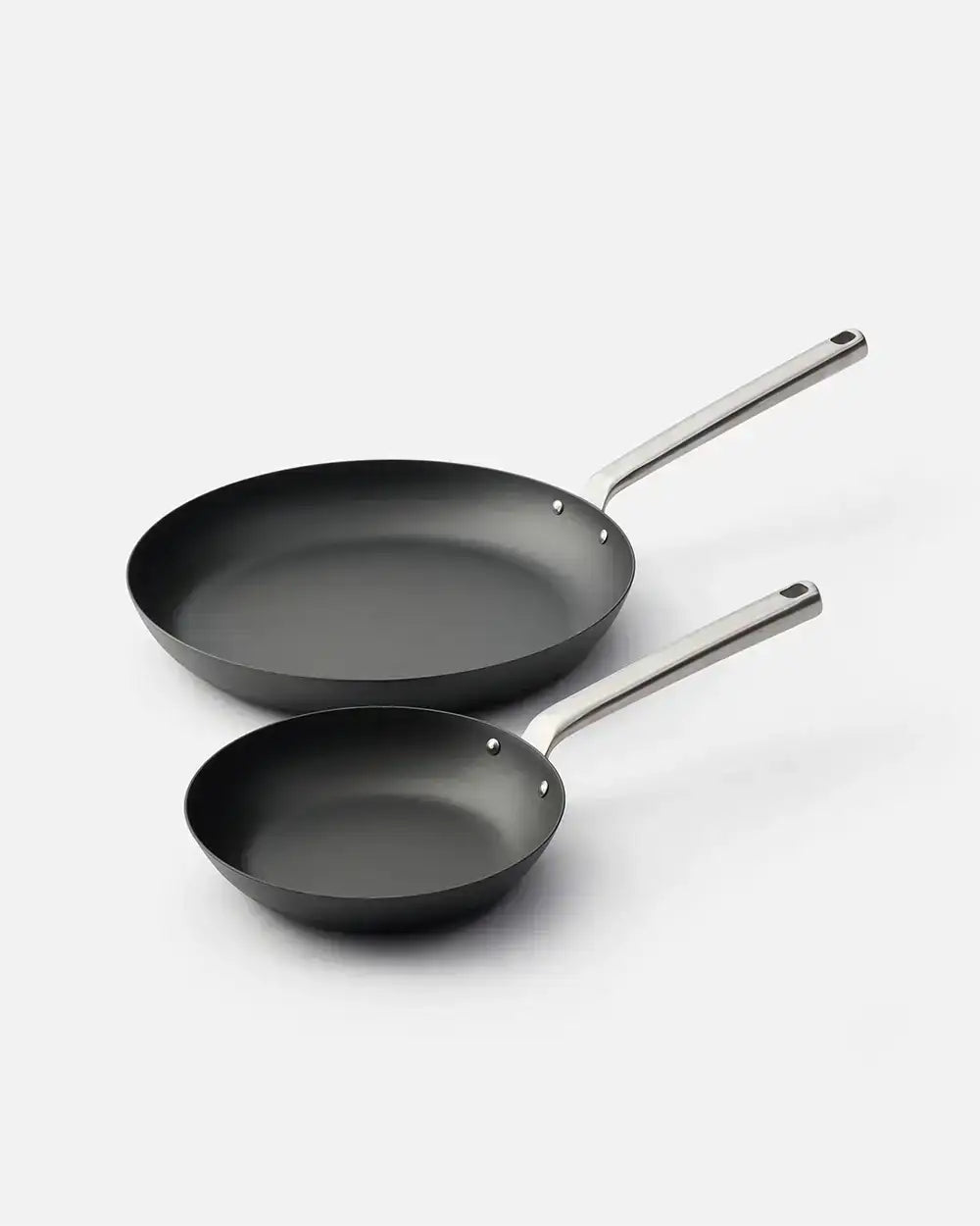 Set of two black nonstick frying pans with stainless steel handles on a white background