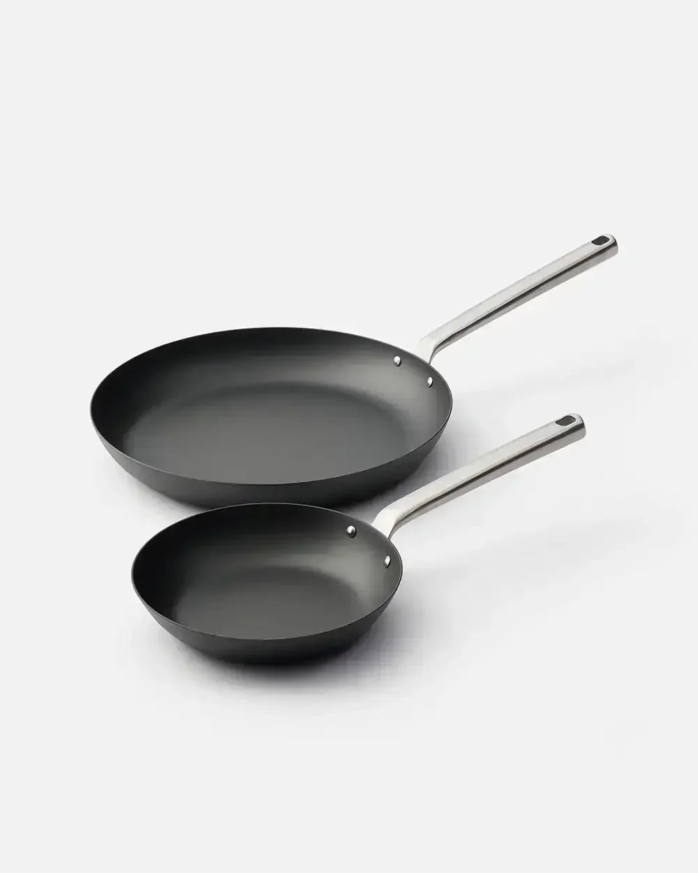 Set of two black nonstick frying pans with stainless steel handles on a white background