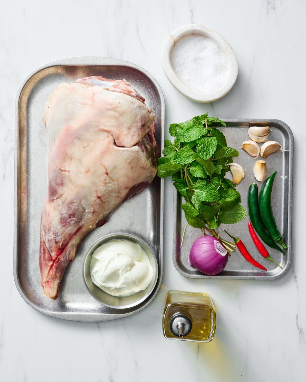 Slow-Roasted Leg of Lamb with Herb Yoghurt Marinade Recipe CookDineHost recipe ingredients flat lay on marble benchtop