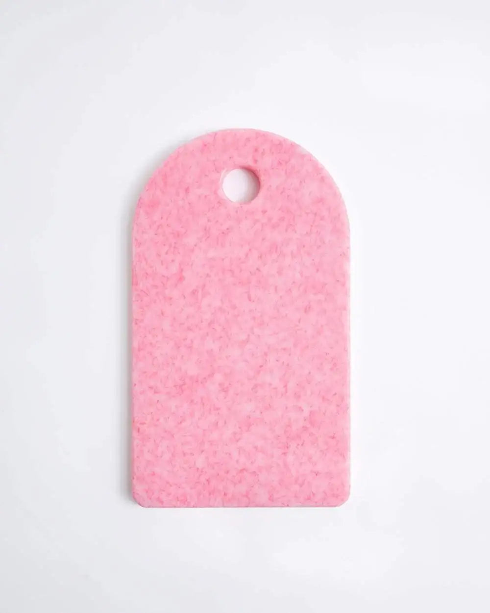 Asoke cutting board in recycled pink material with rounded top and hanging hole, kitchen accessory