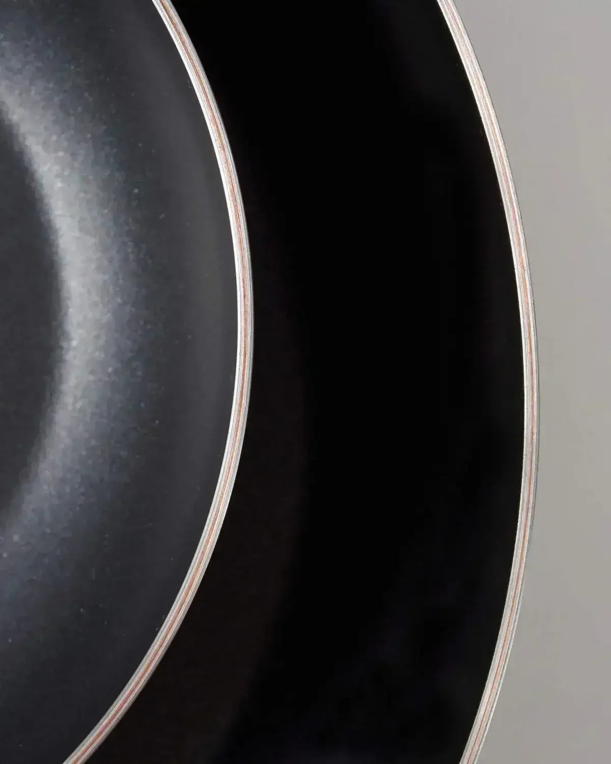 Close-up of two black non-stick frying pans with silver rims