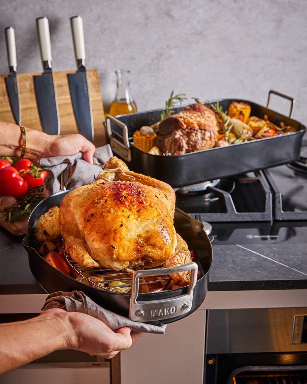 MAKO Aero Non-Stick Oval Chicken Roaster CookDineHost lifting cooked chicken out of oven