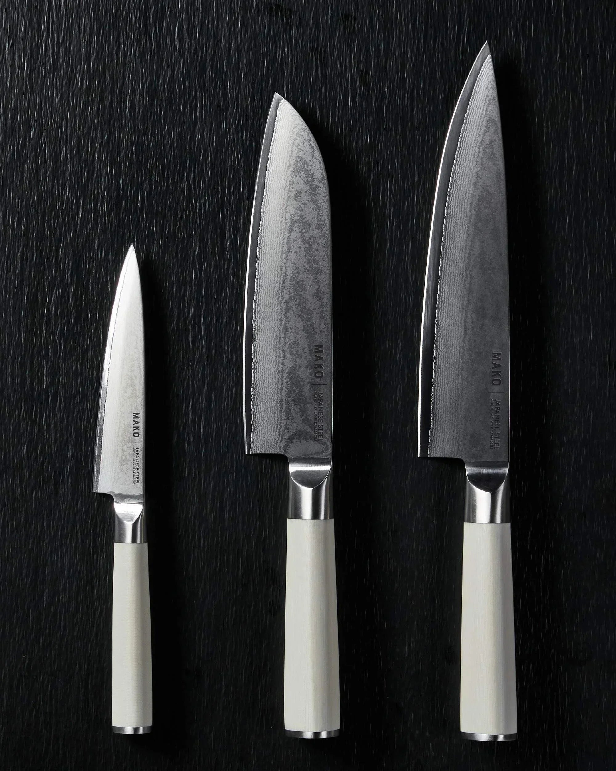 Mako Japanese steel knife set with cream handles on black textured surface, designed by Marion Grasby