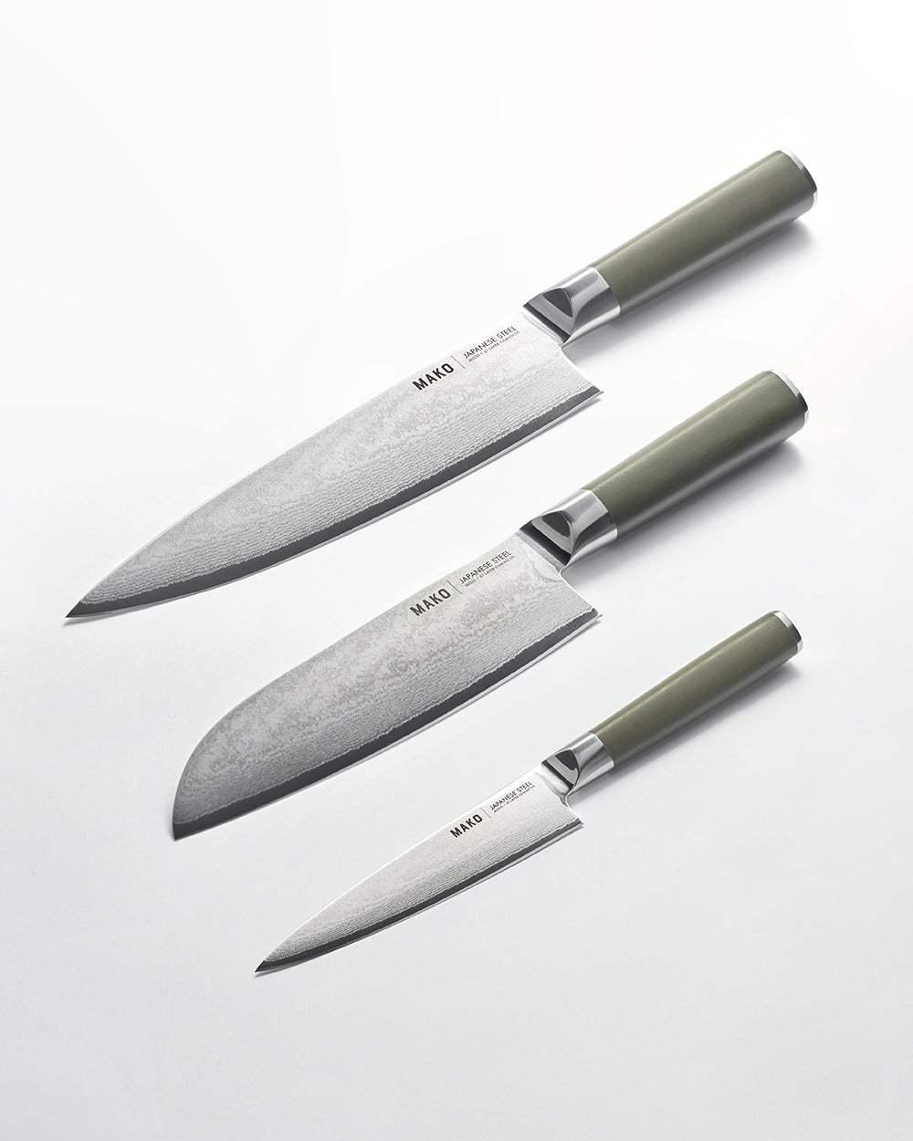 Set of three Mako Japanese steel kitchen knives with olive green handles on white background