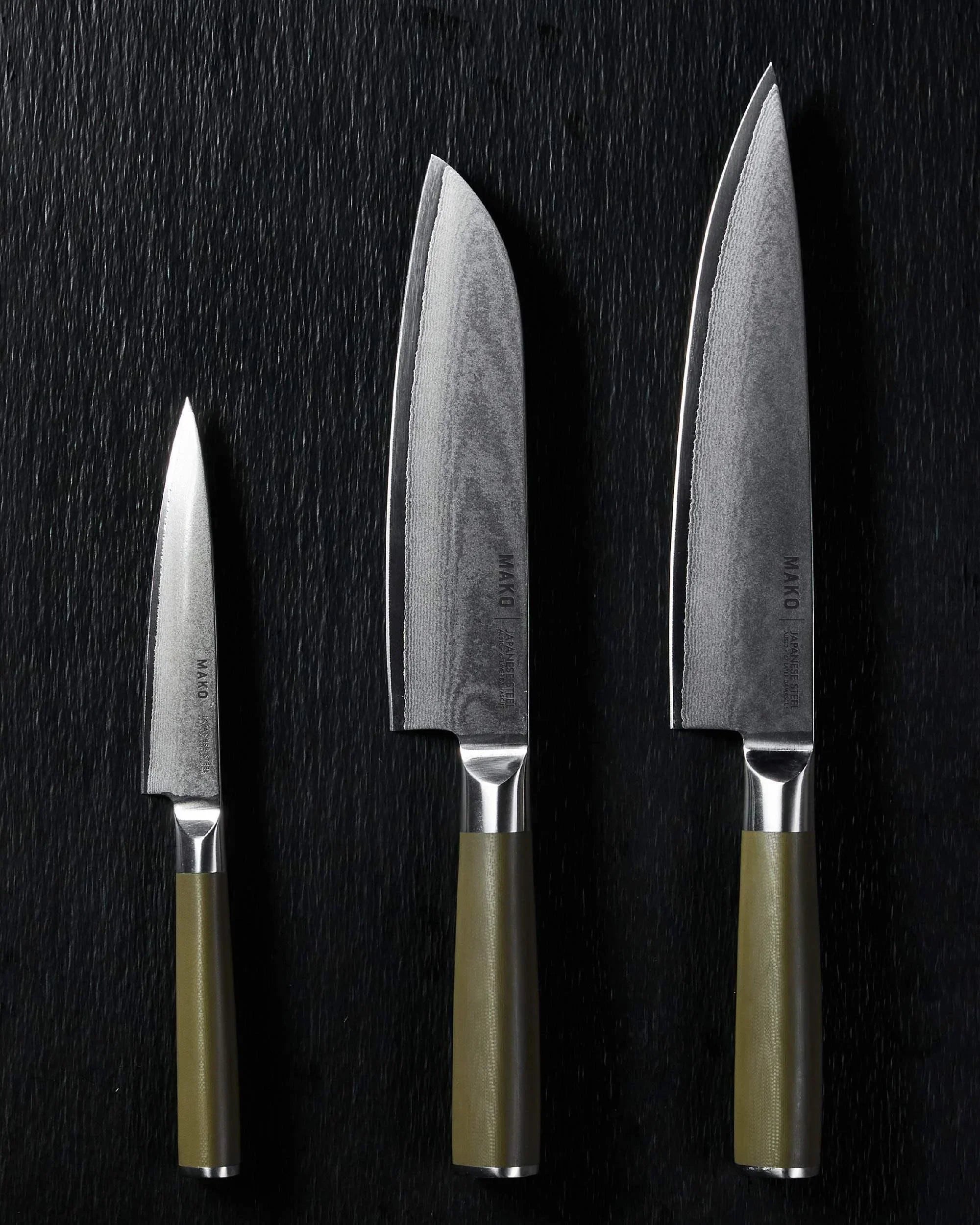 Set of three Mako Japanese steel kitchen knives with olive green handles on black background