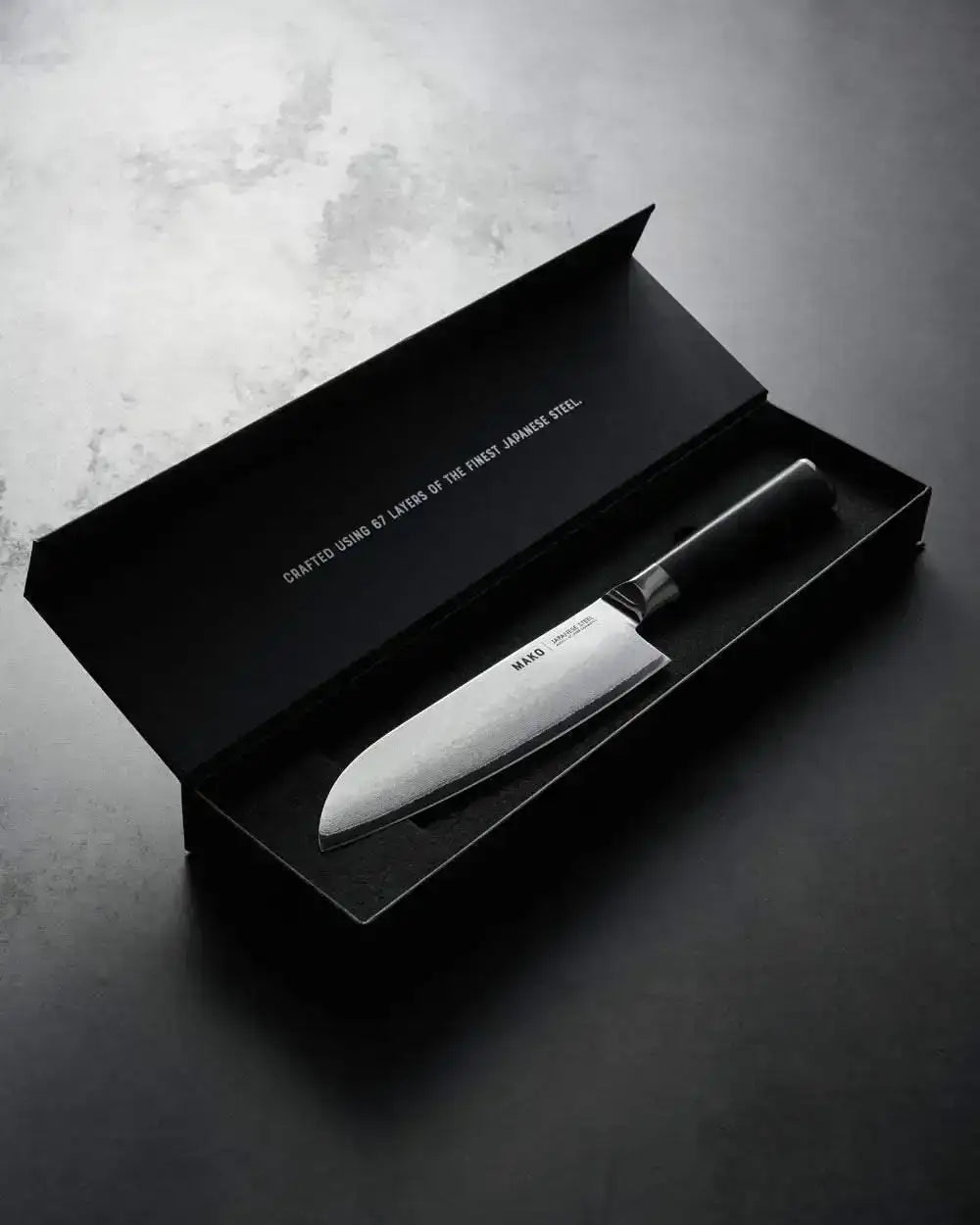 Mako Japanese steel Santoku knife in black gift box with text about 67 layers, designed by Marion Grasby