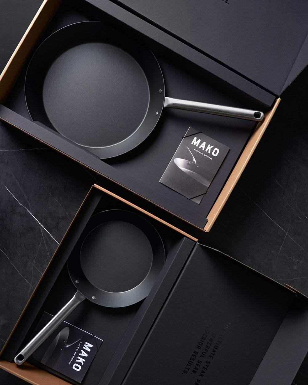 MAKO Black Steel Steak Pan Set CookDineHost - flat lay in box packaging on black table