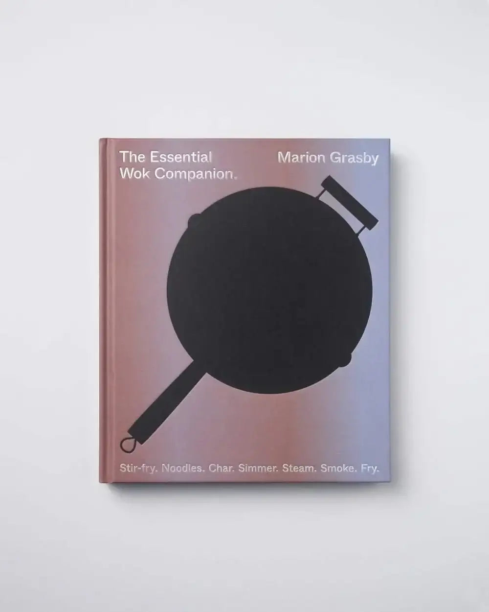 The Essential Wok Companion cookbook by Marion Grasby with a black wok silhouette on the cover, available at CookDineHost.