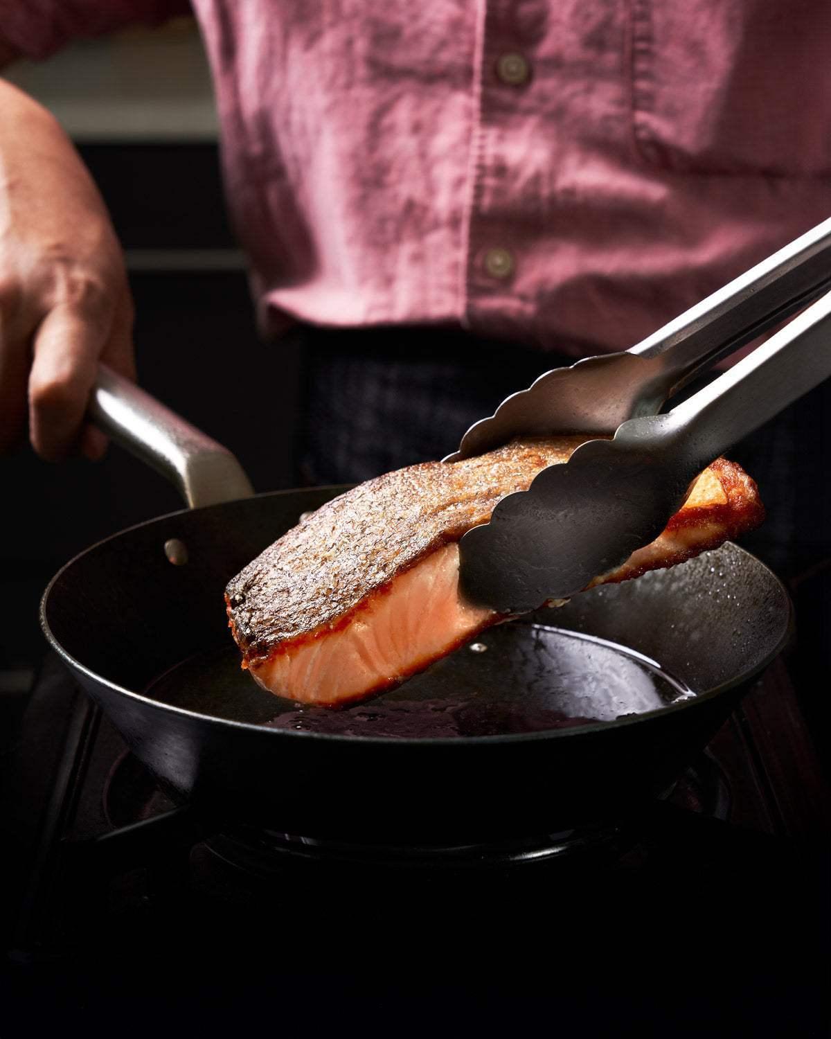 MAKO Black Steel Mini Sear Pan CookDineHost - salmon lifted out with tongs