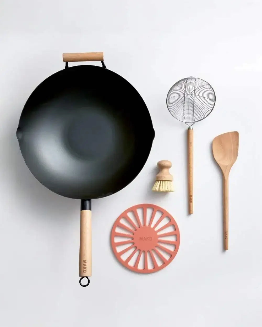 Mako black steel wok bundle with wooden handle, skimmer, brush, spoon, and silicone trivet by Marion Grasby