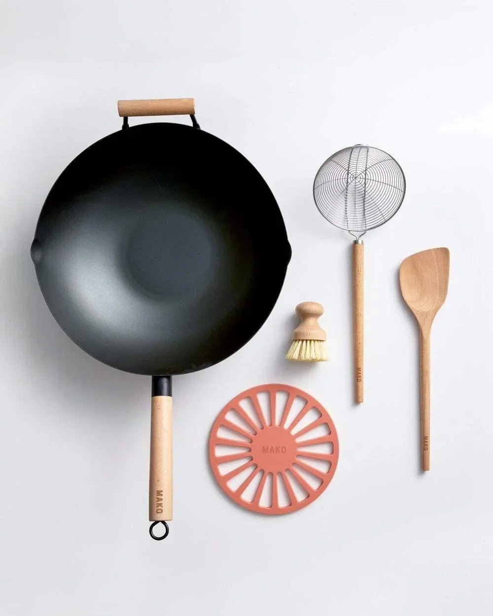 Mako black steel wok bundle with wooden handle, skimmer, brush, spoon, and silicone trivet by Marion Grasby