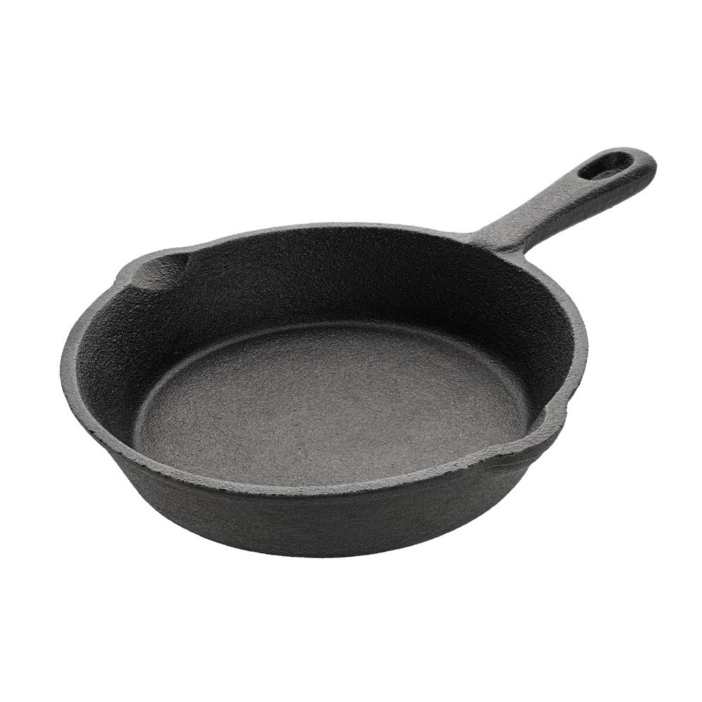 Cast iron skillet with a short handle on a white background