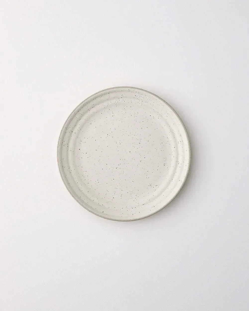 Asoke speckled side plate by Marion Grasby, minimalist white ceramic with subtle black flecks