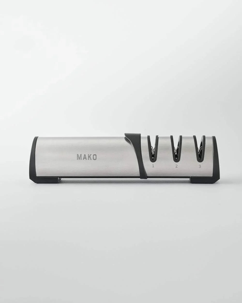 Mako branded stainless steel and black three-stage knife sharpener on white background