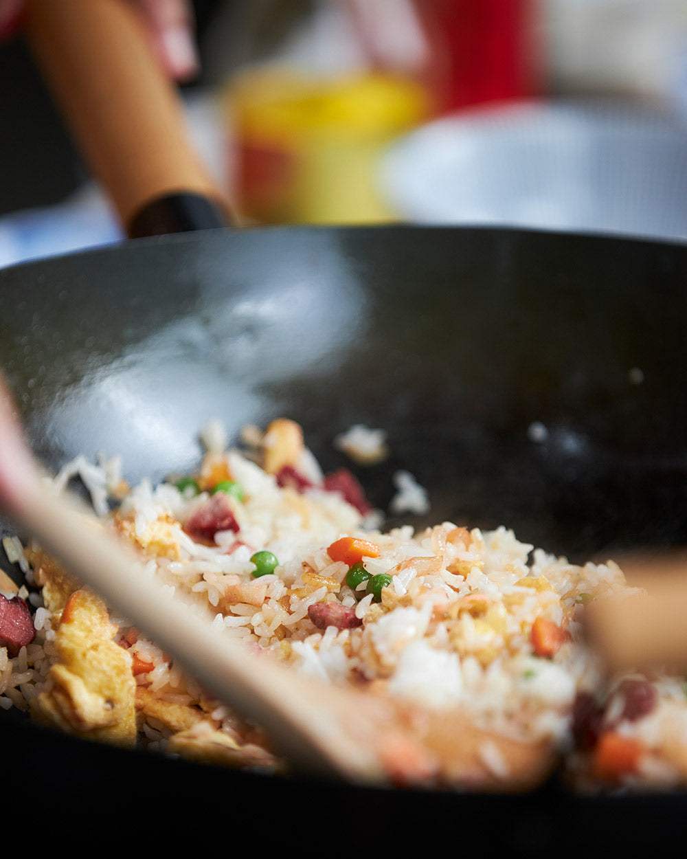 Stir-frying homemade fried rice with vegetables and eggs in a nonstick wok