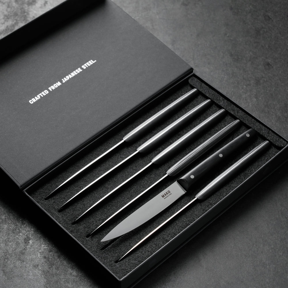 MAKO Steak Knives Black set of 6 in box on black marble  bench top. Diagonal angle