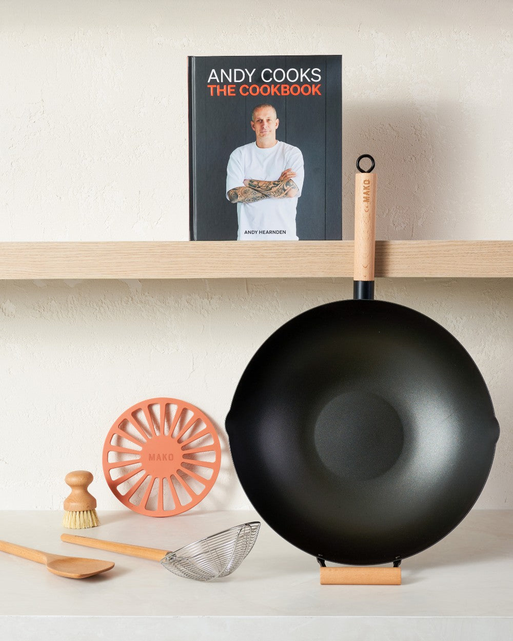 Andy Cooks The Cookbook & MAKO Black Steel 14 Wok Kit Lifestyle on shelf and bench
