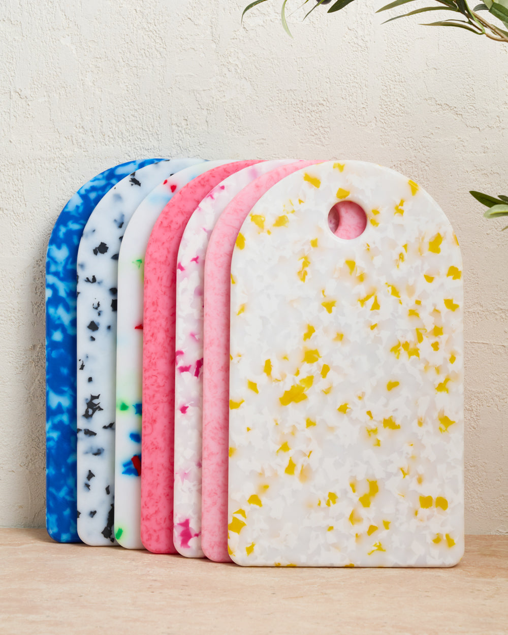 Colorful terrazzo-patterned cutting boards standing upright on a kitchen surface