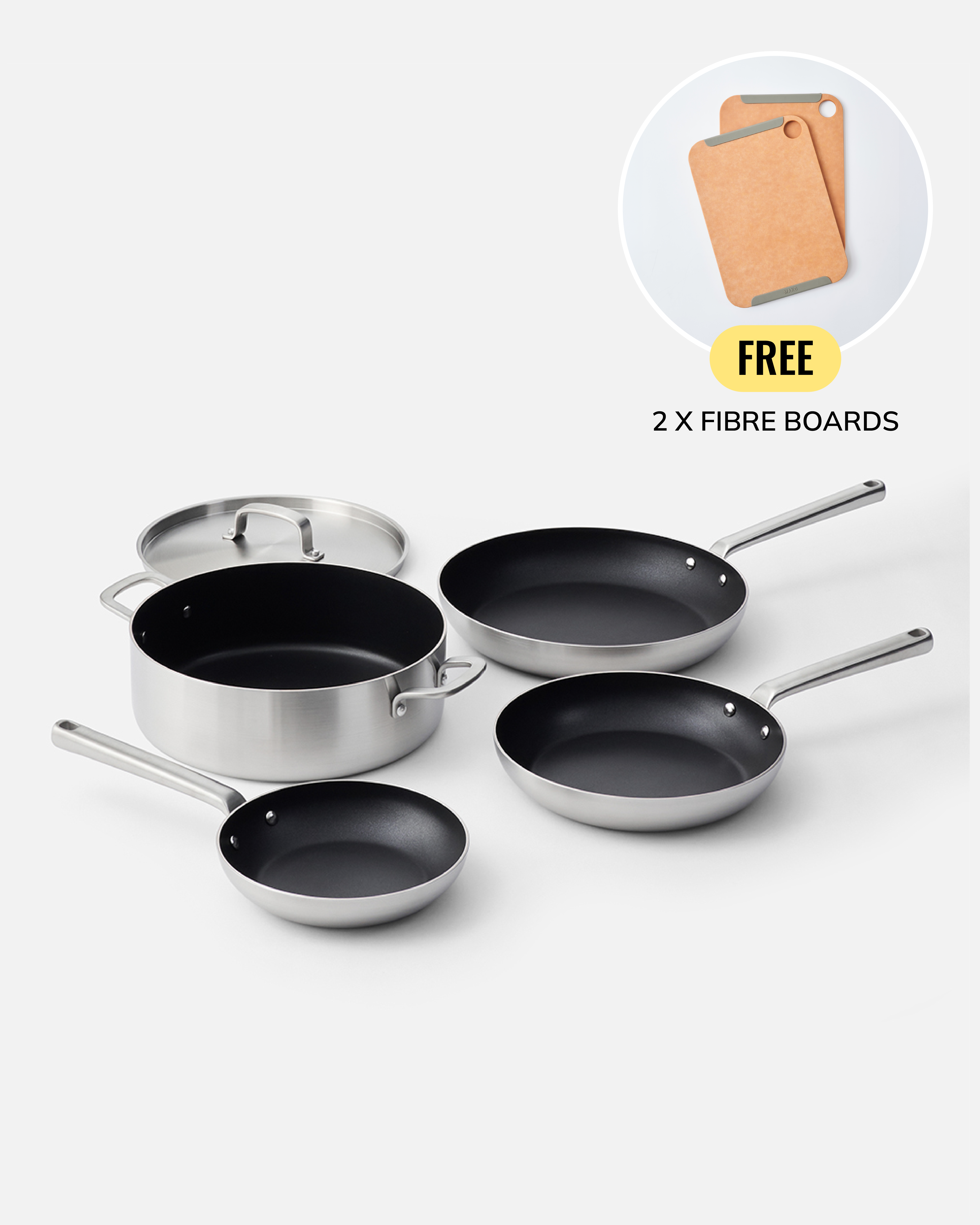 A set of stainless steel cookware including a saucepan with lid, two frying pans, and two skillets, arranged on a light gray background. A circular inset in the top right shows two cork fibre boards with the text 'FREE 2 X FIBRE BOARDS'.