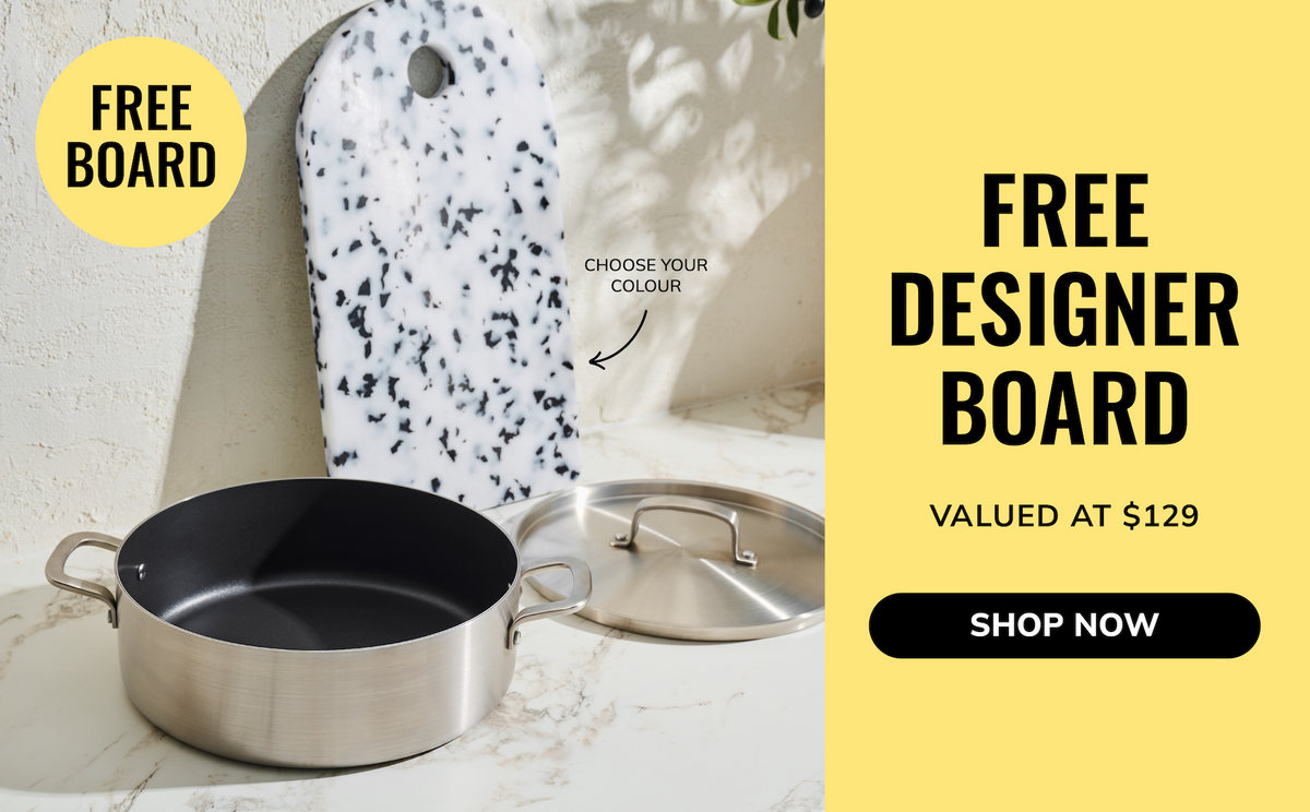 Promotional graphic for a designer cookware board set, showing a speckled white cutting board with black spots, a stainless steel saucepan, and a glass lid on a marble surface next to a bright yellow sidebar with text reading 'FREE DESIGNER BOARD' and 'SHOP NOW'.