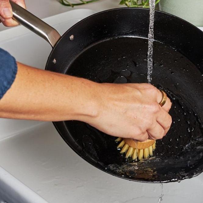 Let your pan cool down before cleaning with warm water, your brush and minimal detergent.