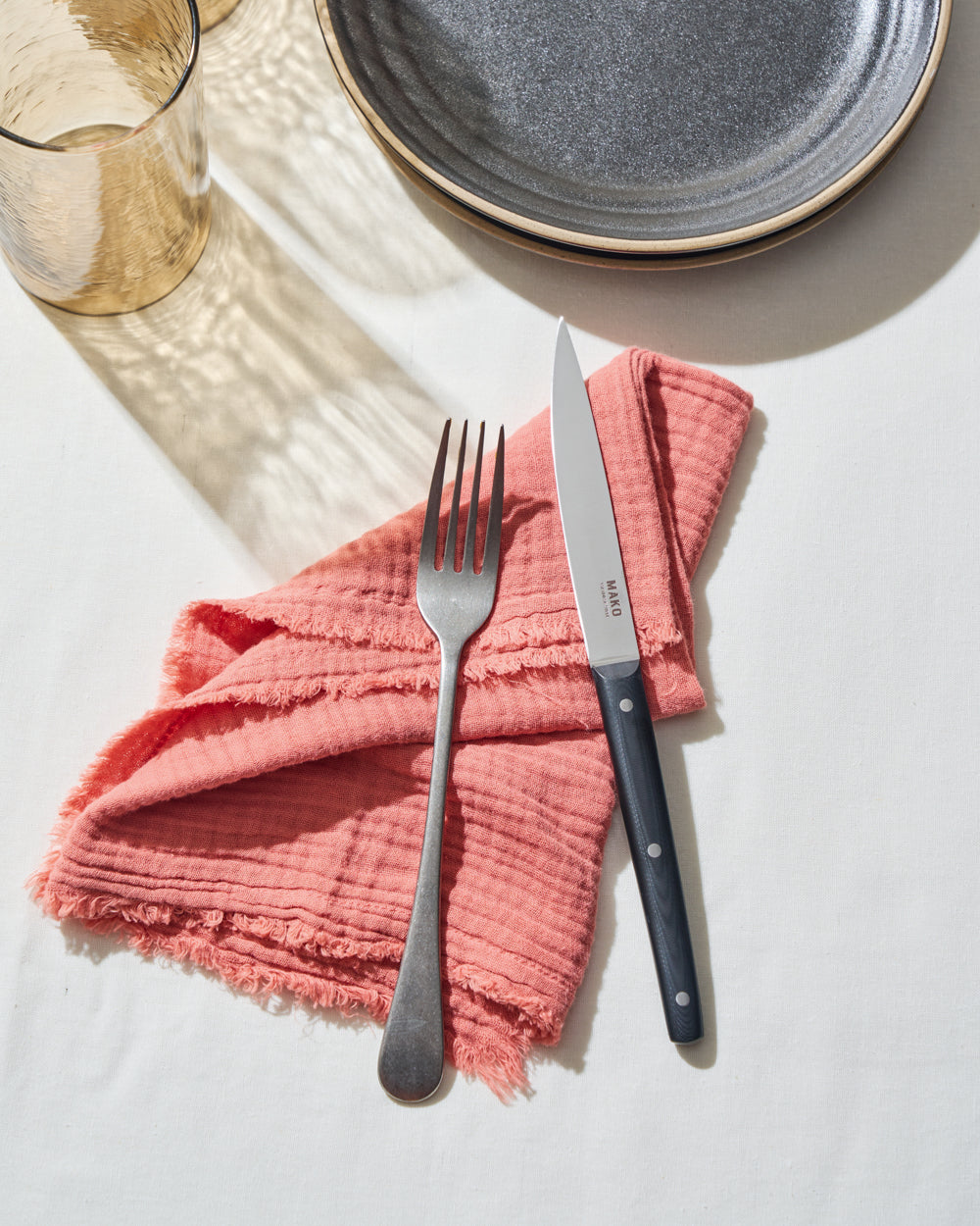 MAKO Steak Knife Set of 6 - Black on thite table cloth with pink napkin glass and charcoal Anaya plates