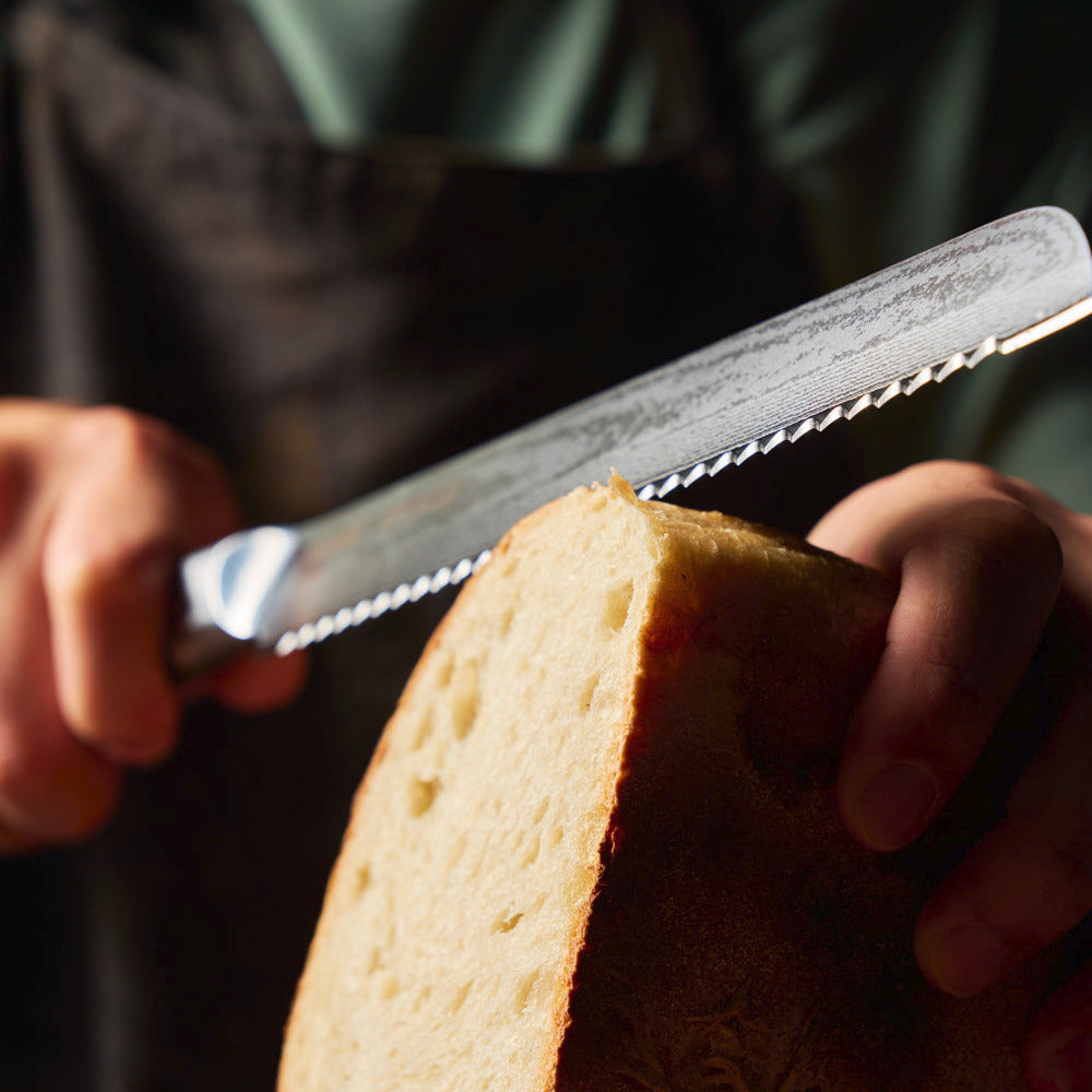 MAKO Japanese Steel Black 8″ Bread Knife in use crafted to stay sharp
